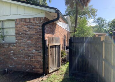 Seamless gutters in black on brick home